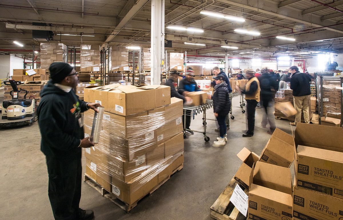 Warehouse worker wrapping a pallet with clear stretch film